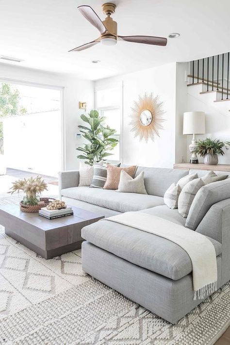 Styled gray living room boasts a white and gray embroidered rug placed beneath a dove gray linen sectional complemented with gray pillows and a gray throw blanket. Salt Interiors, Vintage Living Room Furniture, Couch Styling, Furnitur Ruang Keluarga, Pure Salt, Pallet Furniture Living Room, Room Deco, Vintage Living Room, Decor Minimalist