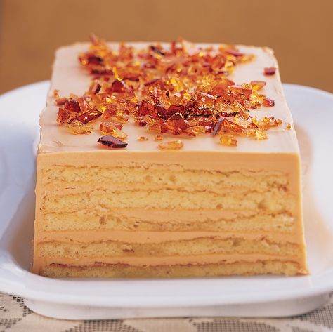 A rich Dobos Torte -- which has alternating layers of yellow genoise cake and Caramel Buttercream -- is topped with coarsely chopped caramelized sugar. The original recipe was created in 1887 by the Hungarian chef whose name it bears. Dessert Recipes With Caramel, Recipes With Caramel, Dobos Torte Recipe, Dobos Torte, Genoise Cake, Christmas Dessert Recipes, Torte Recipe, Caramel Buttercream, Buttercream Frosting Recipe