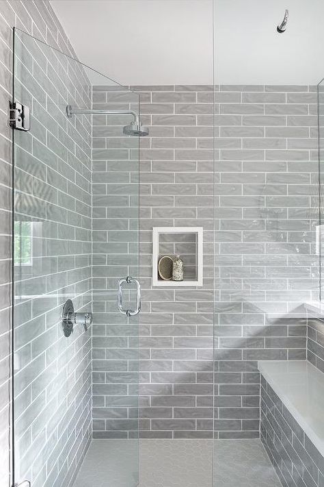 Walk-in shower designed with gray shower tiles, a white quartz bench, and light gray hexagon floor tiles. Hexagon Shower Floor, Gray Shower Tile, Kleiner Pool Design, White Tile Shower, Grey Bathroom Tiles, Shower Tiles, Shower Wall Tile, Walk In Shower Designs, Shower Floor Tile