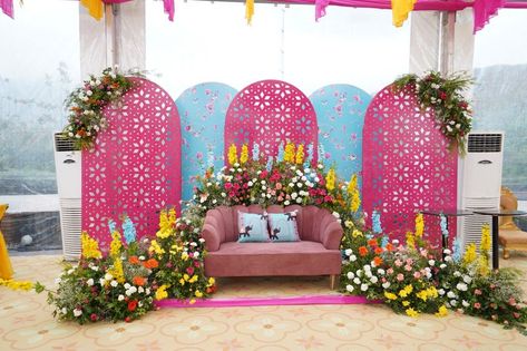 Photo From The vibrant and colourful monsoon Mehndi/Bhaat/Haldi function - By Jyotica Anand Mehndi Function Backdrop, Haldi Decor Backdrop, Bhaat Ceremony Decor, Chaab Decoration Ideas Wedding, Haldi Backdrop Stage Decorations, Pink Haldi Decor, Mehendi Setup Mehndi Decor, Mehandi Stage Decoration, Haldi Stage Decor