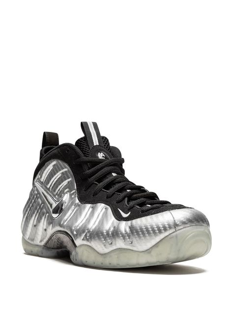 "Find NIKE Air Foamposite Pro Surfer Sneakers on Editorialist. Everything that glitters isn't gold. Here, chrome serves as a sweet substitute on the new Nike Air Foamposite Pro \"\"Silver Surfer\"\". Released in 2017, during the 20th anniversary year of the Foamposite, the shoe glimmers in Metallic Silver on a carbon fibre upper. A chrome Swoosh sports a hue akin to the famed Marvel character from which these kicks draw its name. Featuring a pull tab at the rear, an ankle length, a lace-up front Air Foamposite Pro, Pro Surfers, Nike Foamposite, Foam Posites, Silver Surfer, New Nike Air, 20th Anniversary, New Nike, Pull Tab