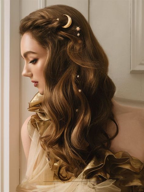 This ethereal hairstyle showcases voluminous waves with delicate star and moon accessories tucked into the hair. Perfect for formal occasions or themed events, it exudes a celestial elegance that complements evening wear beautifully. Celestial Bridal Hair, Celestial Hairstyles, Celestial Wedding Hair, Ethereal Hair, Celestial Hair, Voluminous Waves, Moon Accessories, Celestial Wedding, Star And Moon