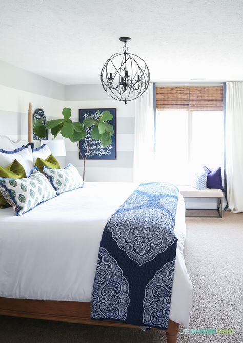 Guest bedroom with woven shades, ribbon trimmed drapes, white bedding, navy blue paisley throw, Doxology canvas, fiddle leaf fig tree, chartreuse velvet pillows and hickory wood bed via Decked and Styled Spring Home Tour - Life On Virginia Street Design Blogs, Bedroom Color Schemes, Blue Spring, Dreamy Bedrooms, Spring Home Decor, Blue Bedroom, White Bedroom, White Bedding, Guest Bedrooms