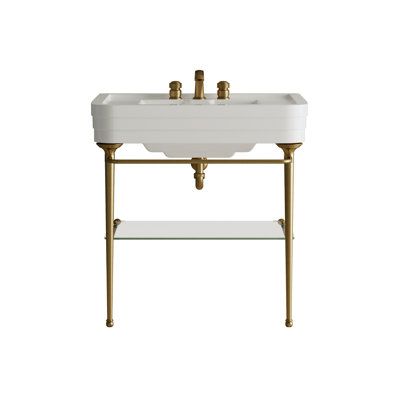 An elegant console that takes the essential beauty of Art Déco architecture and reinterprets this with a focus on the most exclusive comfort. The brass frame has a molded base sculpted into three sections that evoke the sculptural shape of the ceramic washbasin and includes three towel rails and a glass shelf. With a bespoke choice of finishes. Finish: Bronze Devon&Devon Nobel Console - Bathroom Sinks in White/Brown | Size 35.25 H x 33.875 W x 22.0 D in | Perigold Console Bathroom Sink, Devon Devon, Console Sink, Art Deco Sculpture, Entertaining Essentials, Glass Shelf, Art Deco Architecture, Bathroom Sinks, Guest Bathroom