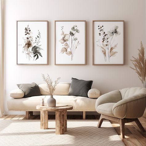 "Elevate your living space with the timeless sophistication of our Minimalist Botanical Print Set in Sepia. This curated trio of watercolor prints features stylized floral and leaf designs, each piece subtly distinct yet harmoniously blending with the others. Rendered in neutral sepia tones, they evoke a sense of calm and contemporary elegance, perfect for any modern living room, cozy reading nook, or stylish office. The natural subjects, combined with a clean, minimalist presentation, offer a v Bedroom Sitting, Triptych Wall Art, Botanical Print Set, Mural Floral, Neutral Wall Art, Living Room Decor Modern, Gallery Wall Set, Botanical Wall Art, Semi Transparent