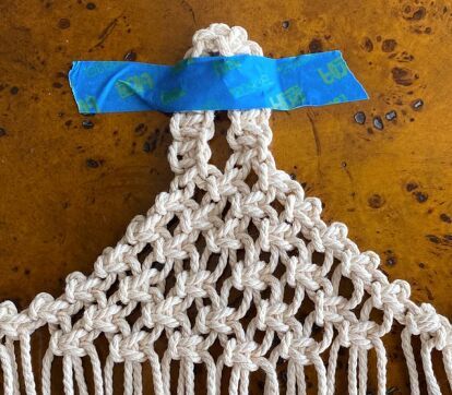 Making this little macramé hanging pod is a bit trickier than a simple wall hanging, but it is well worth the effort. I already have a ton of ideas in mind for these little baskets. They would look adorable used for storage on a nursery wall. I also plan on making some for my son’s upcoming wedding in an actual old barn; how sweet would these look hanging on rustic wooden columns? So take a little time, learn this technique, and you’ll find a myriad of uses for your macramé hanging pod… Macrame Wall Pocket Diy, Macrame Wall Pocket, Diy Outdoor Candles, Basket Macrame, Simple Wall Hanging, Wooden Plant Pots, Macrame Basket, Wooden Columns, Colorful Wall Hanging