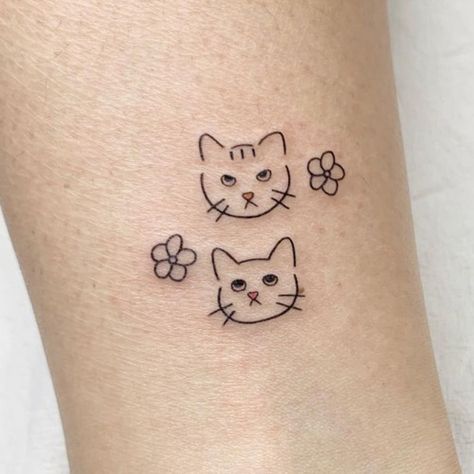 Top Minimal And Small Cat Tattoos You'll Want To See | Inku Paw Mean Cat Tattoo, Minimalist Two Cat Tattoo Designs, Kitten Paws Tattoo, Tiny Matching Cat Tattoos, Cat Tattoo Small Simple Outline, Three Cats Tattoo Simple, Cat Paws Tattoo Ideas, Minimalist Kitten Tattoo, Two Cats Tattoo Ideas