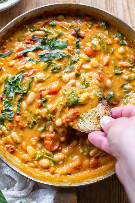 The comforting flavors of this Creamy Vegan Tomato White Bean Stew make the perfect easy lunch or dinner. This dairy-free & plant-based recipe is packed with wholesome ingredients, like protein-packed white beans, cherry tomatoes, and nutrient-dense greens. Learn how to make this easy and satisfying vegan stew in just 25 minutes. Tomato And White Bean Stew, Tomato White Bean, White Bean Tomato, White Bean Stew, Vegetarian Stew, White Bean Recipes, Yummy Vegan Food, Vegan Stew, Beans Curry