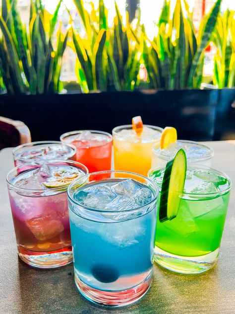 Rainbow drinks on a table. Drink The Rainbow Mexico, Rainbow Cocktail Party, Colour Cocktail Party, Coloured Cocktails, Rainbow Dinner Party, Rainbow Bachelorette, Rainbow Cocktails, Pride Cocktails, Rainbow Bachelorette Party