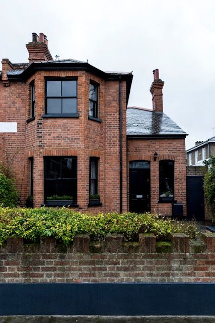 RED BRICK HOUSES WITH BLACK TRIM - design indulgence Brick House With Black Trim, House With Black Trim, Red Brick House Exterior, Red Brick Exteriors, Industrial Exterior, Brick Cottage, Victorian Style Homes, House Trim, Cottage Exterior