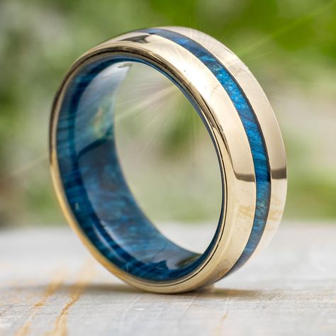 Thisbluemen's wedding band features a colorful, wood inlay up the center and a coordinating layer of the blue wood inside. Crafted in solid gold in your choice of yellow, rose or white and polished to perfection! Keep in mind, thismen's ring can be customized to feature a different wood species, if desired.This ring comes with FREE Ring Armor Waterproofing ($75 value).RING LAYOUT Ring Width: 8mmRing Sleeve: Blue Box Elder Burl Ring Profile: RoundRing Finish: Polished3mm 14K Gold2mm Blue Box Elde Men's Wedding Rings Rose Gold, Gold And Blue Mens Wedding Band, Blue Men’s Wedding Band, Turquoise Men’s Wedding Ring, Men’s Wedding Band With Sapphire, Men’s Sapphire Ring, Sapphire Wedding Band Men, Men Engagement Ring For Him, Men’s Engagement Ring