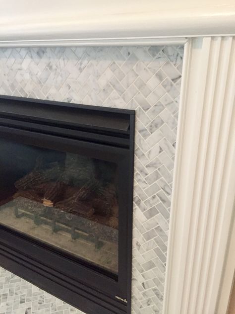 2x1 Italian marble herringbone tile fireplace renovation White Herringbone Fireplace, Fireplace Herringbone Tile, Fireplace Herringbone, Herringbone Tile Fireplace, Herringbone Fireplace, Tile Makeover, Marble Herringbone Tile, Fireplace Renovation, Marble Herringbone