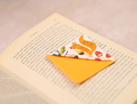 Want to spice up your reading routine with a touch of flair? Why not jazz it up with a DIY fabric corner bookmark! Say goodbye to dog-eared pages and hello to a stylish and practical accessory for your favorite reads. In this article, we'll walk you through creating your own unique corner bookmark using fabric scraps and a dash of creativity. Whether you're a seasoned sewing pro or just starting out, this project is a perfect way to unleash your imagination and personalize your reading experienc Sewn Corner Bookmarks, Cloth Corner Bookmarks, Page Corner Bookmarks, Corner Bookmark Sewing Pattern, Corner Bookmarks Diy Free Printable, Felt Corner Bookmarks Diy, Corner Bookmarks Diy, Using Fabric Scraps, Reading Routine