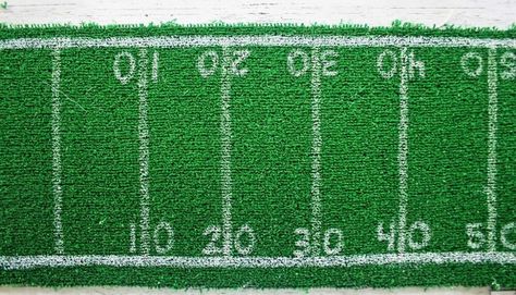 If you will be hosting any kind of football-themed party, you need football-themed table decorations. What better tabletop decor than a diy football field table runner?I will be throwing a Super Bowl party this year and have been wanting a football field table runner for the event. So I decided to make one.And you know what?It’s easier and cheaper than you think to make a football field table runner. Supplies to DIY a Football Field Table Runner Fake turf Scissors or craft knife W… Diy Football Field, Diy Artificial Turf, Party Buffet Table, Super Bowl Decorations, Runner Tips, Fake Turf, Football Diy, Table Runner Diy, Football Theme Party