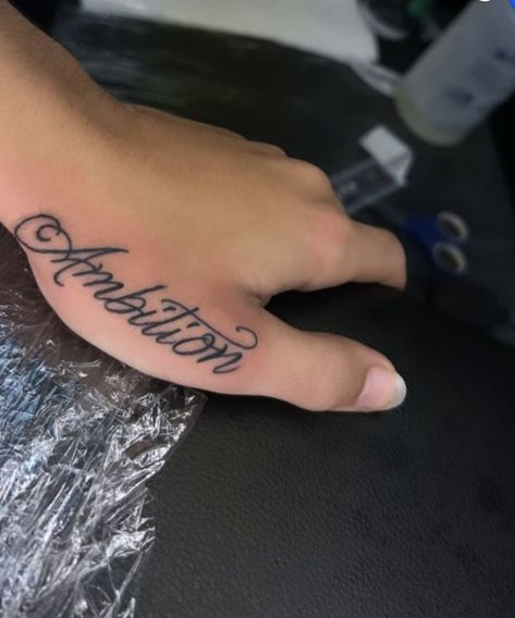 Ambition Hand Tattoo, Cursive Hand Tattoo, Name Tattoos For Men Forearm, Lettering Hand Tattoo, Hand Name Tattoos, Ambition Tattoo, Name Tattoo On Hand, Cool Finger Tattoos, Side Hand Tattoos