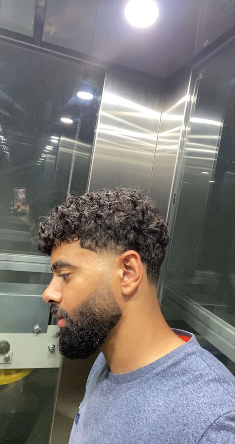 Taper Vs Fade Haircut Difference to Know 2023 Low Taper On Curly Hair, Curly Hair Fade With Beard, Mens Curly Hairstyles With Beard, Taper Fade Haircut Curly Hair Men, Low Taper For Curly Hair, Curly Hair Men Haircut Fade With Beard, Low Taper Short Curly Hair, Tapered Curly Hair Men, Haircut For Afro Hair Men