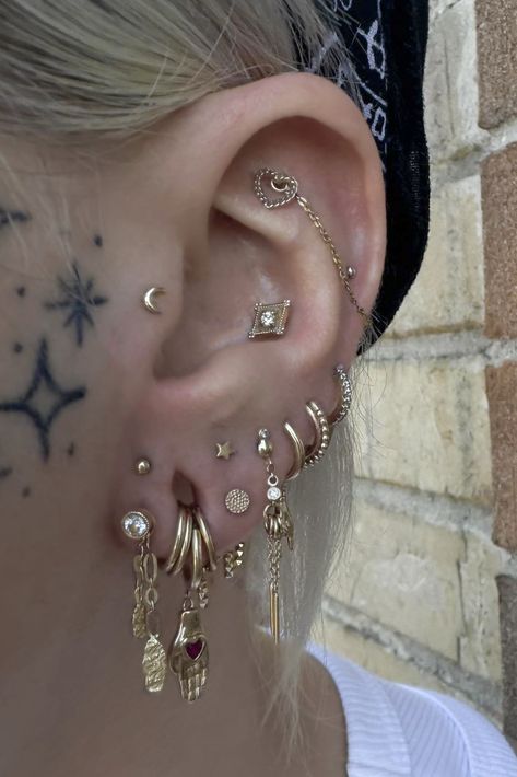 Find @adornedbyamelia (IG) at Scarecrow Galleries Tattoo for all your piercing needs.  Tag us in your ear curations starring @MayaJewelry for a chance to get featured.  Designs featured in Amelia's curation: Heart in Chains — Flat Lucidity — Conch Golden Age Charm — Lobe Stretched Ear Curation, Piercing Ear Design, Ear Conch Piercings, Gold Piercings Aesthetic, Stacked Ear Lobe Piercing, Ear Piercings With Gauges, Asymmetrical Ear Piercings, Ear Piercing Ideas Silver, Coin Slot Piercing