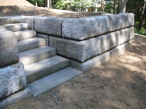 Here’s a gorgeous design using concrete blocks. Massive concrete blocks, that is. If you’re browsing through any cinder block retaining wall ideas, this one may be the design to stop at. The blocks are neutral grey, but huge and textured to add interesting character and depth to any garden space. The stone steps cut into the massive blocks looks almost like a fairy tale scene in the woods. This is a great idea for a summer getaway home or lodge in the mountains. Inexpensive Retaining Wall Ideas, Cinder Block Garden Wall, Cheap Retaining Wall, Concrete Block Retaining Wall, Natural Stone Retaining Wall, Retaining Wall Steps, Retaining Wall Ideas, Boulder Retaining Wall, Backyard Retaining Walls