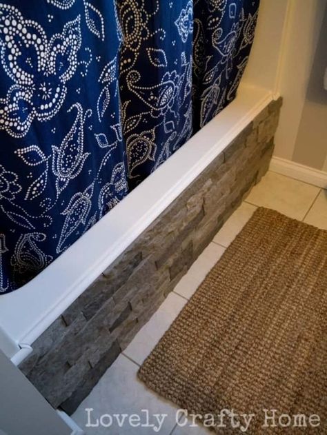 front of bathtub covered with grey airstone, blue print curtain to cover shower and a rug in front. Cheap Diy Bathroom Makeover, Diy Bathroom Makeover Ideas, Bathtub Wall Panels, Tiles Painting, Tub Surround Ideas, Fun Tile, Bathrooms Tiles, Bathroom Makeover Ideas, Tiled Bathrooms