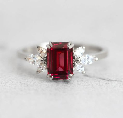 The Janine ring with gorgeous umba garnet and marquise white diamonds on the side, is truly a ring that will not go unnoticed. With it’s jaw dropping beautiful red color it is mesmerising and any lady would be happy to have this as her engagement ring. Details Center stone Gemstone: Natural Umba valley garnet Color: re Luxury Marquise Red Ruby Ring, Luxury Ruby Marquise Cut Rings, Luxury Red Marquise Ruby Ring, Red Baguette Cut Lab-created Ruby Ring, Red Baguette Cut Diamond Ring, Marquise Ruby Ring With Center Stone For Promise, Marquise Ruby Ring With Diamonds, White Gold Marquise Cut Ruby Ring For Wedding, Red Diamond Baguette Cut Rings