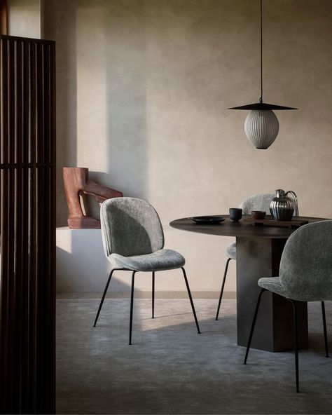 Beetle Dining Chair, upholstered in Dedar Belsuede 012. The darkest of the four Beetle Chairs in the GamFratesi Edit is upholstered with chenille in dark green. The linen in the warp adds a vivacity to the muted hue that embodies the natural tranquility of organic growth and renewal. The overall effect evokes a modern noir ambience while capturing the bohemian zeitgeist of the 1970s. Gubi Beetle Dining Chair, Fully Upholstered Dining Chair, Gubi Chair, Beetle Chair, The Beetle, Outdoor Pendant Lighting, Perforated Metal, Ergonomic Chair, Upholstered Dining Chairs