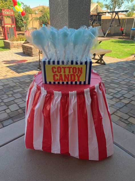 This set up was so easy to make as a cotton candy display. We wrapped a cardboard box in wrapping paper and cut spall holes at the top of the box to hold all of the yummy cotton candy. Cotton Candy Stand Diy, Cotton Candy Stand Display Diy, Cotton Candy Booth, Cotton Candy Display, Ward Halloween Party, Candy Booth, Halloween Carnival Games, Circus Themed Birthday Party, Games For Seniors