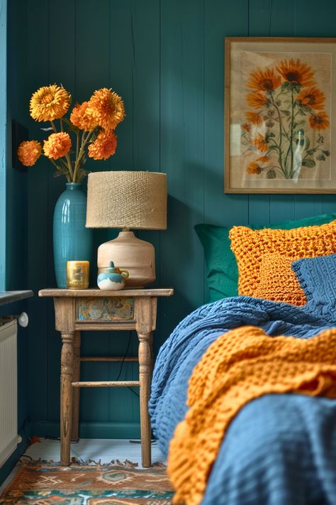 Craving bold colors and vintage vibes? This teal boho nightstand is a showstopper against its vibrant wall backdrop. Golden marigolds and knitted bed textures add an eclectic charm that I can’t get enough of. It’s a joyful space for both day and night. Why not make a statement with your own boho nightstand setup? Blue Peacock Bedroom, Teal Gold Bedroom, Unique Nightstand Ideas, Teal And Gold Bedroom, Nightstand Inspiration, Boho Nightstand, Nightstand Ideas, Unique Nightstand, Teal Bedroom