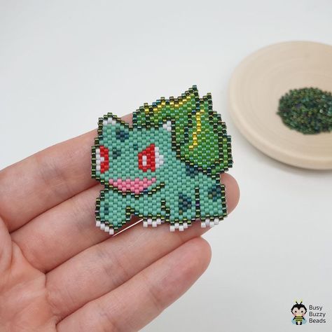 Miyuki Delica beading patterns on Instagram: “Meet another Pokemon - Bulbasaur, my fave too🥰 • ❗️Please do not copy from the picture. • • • #tissageperler #perlesmiyuki…” Beaded Pokemon Pattern, Pokemon Seed Bead Patterns, Seed Bead Pokemon, Brick Stitch Pokemon, Brick Stitch Dinosaur, Pokemon Beads Pattern, Beaded Pokemon, Stitch Bead Pattern, Pokemon Earrings