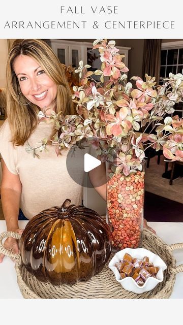 Janine Graff on Instagram: "Fall Vase Arrangement & Centerpiece 🍁 Add those cozy autumn vibes to your home with this simple trick when creating an arrangement with florals or foliage! Just fill your vessels with a cardboard paper towel to get started. 

By using a cardboard roll before adding seasonal fill like mini pumpkin pods or any other fill of your choice, such as candy, potpourri, decorative stones, etc, to your vase, you’ll create a stable arrangement without the need for extra fillers. Your florals or stems will remain well-structured, allowing you to easily create a centerpiece that is both versatile and efficient!

To shop my vase arrangement and centerpiece decor, comment LINK and I will message you all the details. 

#fallarrangement #falldiy #fallcenterpiece #fallvibes🍁" Large Glass Vase Filler Ideas, Glass Vase Filler Ideas, Fall Vase Filler, Janine Graff, Fall Vase, Vase Filler Ideas, Large Glass Vase, Buffet Decor, Decorative Stones