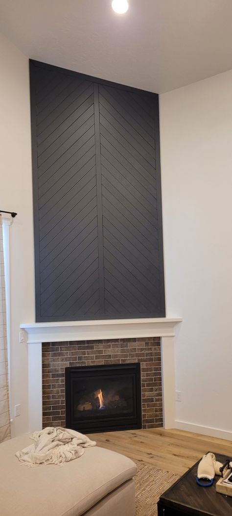 This fireplace focal point was designed by me and created by my husband using 3.5" MDF boards from Home Depot. Now needing to find farmhouse decor to go with our modern farmhouse theme. Chevron Wood Fireplace Wall, Chevron Wall Panelling, Chevron Shiplap Wall, Chevron Shiplap Fireplace, Chevron Fireplace Wall, Chevron Accent Wall, Chevron Fireplace, Mac Desk, House Diys