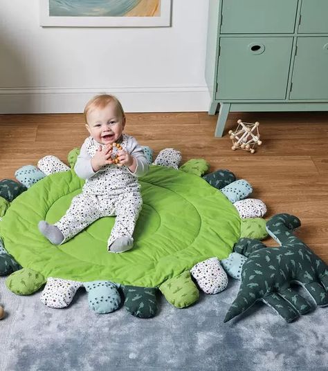 How To Make Playmat with Dino Pillow and Overalls Online | JOANN Dinosaur Playmat, Playmat Diy, Diy Baby Play Mat, Dino Pillow, Play Mat Diy, Educational Playroom, Round Play Mat, Baby Floor Mat, Baby Diy Projects