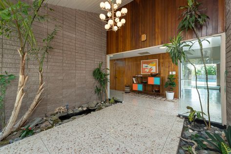 Hallway and Terrazzo Floor The stunning interiors feature an authentic midcentury-modern material palette that includes original terrazzo flooring, brick, and warm wood paneling. Photo 3 of 11 in Step Back in Time in This Midcentury Now Asking $1.4M Mid Century Modern Hallway, Terrazzo And Wood, Mid Century Tile, Modern Terrazzo, Terrazzo Floors, Modern Flooring, Midcentury Home, Modern Hallway, Terrazzo Flooring