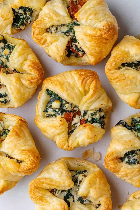 These crispy Spinach Puffs are the perfect appetizer. Filled with spinach, ricotta, feta and sun dried tomatoes for a flavor bomb in each bite! Crispy Spinach, Spinach Puffs, Spinach Puff, How To Make Spinach, Cheese Puff Pastry, Brunch Spread, Spinach Ricotta, Frozen Puff Pastry, Party Appetizer