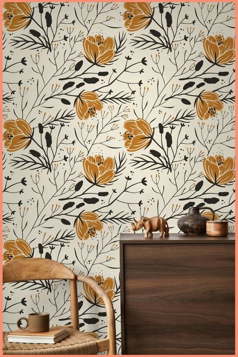 Floral wallpaper with mustard and black flowers behind a wooden cabinet and chair.