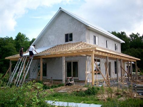 House Plans with Wrap around Porches | Porch under construction - putting down the metal roofing. Saltbox House Plans, House With Front Porch, Porch Roof Design, Salt Box House, Saltbox House, Porch Kits, Straw Bale House, Saltbox Houses, House Front Porch