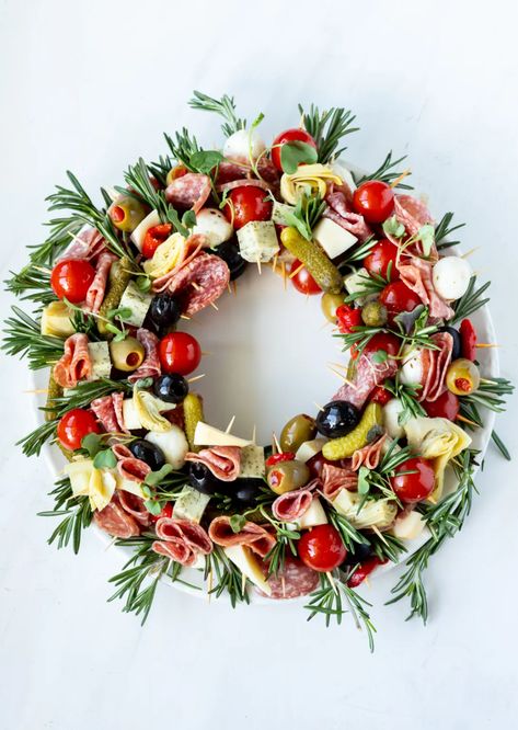 Making a Christmas Charcuterie Wreath is an easy and fun holiday appetizer idea. Antipasto skewers arranged into a festive wreath shape then decorated with rosemary will be a show stopping dish for all of your parties and feasts. #charcuterie #christmasrecipes #antipasto Wreath Shaped Charcuterie, Easy Christmas Canapes, Christmas Appetizer Wreath, Festive Buffet Ideas, Charcuterie Skewers Ideas, Charcuterie Wreath Christmas, Christmas Charcuterie Board Holiday Parties, Charcuterie Wreath Board, Christmas Feast Dinner