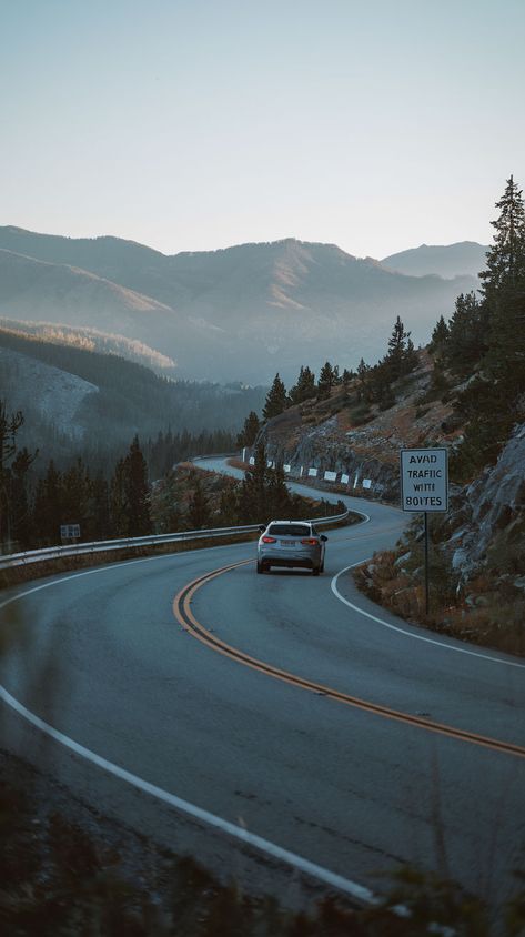 A car driving along a winding scenic route through mountainous terrain. Kancamagus Highway, Pacific Coast Highway, Scenic Byway, Scenic Beauty, Scenic Routes, Road Trip Usa, Pacific Coast, The Pacific, Drive