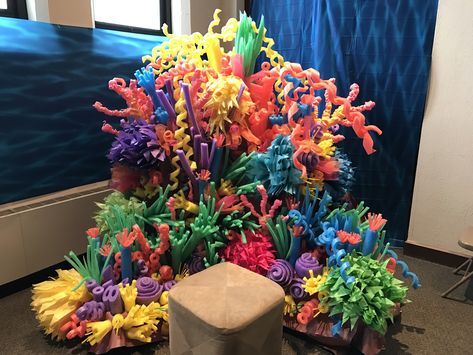 Pool noodle coral reef photo backdrop. Also includes tissue paper anemones and great stuff coral on a skewer Pool Noodle Coral Reef, Diy Coral Reef, Pool Noodle Coral, Paper Tree Classroom, Diy Coral, Under The Sea Decorations, Ocean Theme Classroom, Ocean Birthday Party, Ocean Birthday