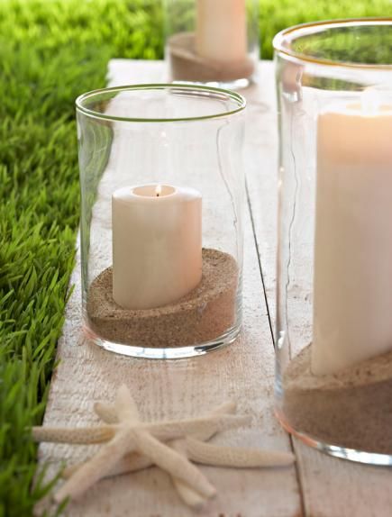 Sand, candles and starfish: For a glowing evening, fill hurricane vases with sand and fat white candles. Place the candle keepers in the center of your table, and after your meal, use them to line porch steps or define the edges of a patio or walkway. Sand Centerpieces, Creative Centerpieces, Summer Centerpieces, Sand Candles, Outdoor Tables And Chairs, Simple Centerpieces, Diy Candle Holders, Flowers Arrangements, Candle Centerpieces