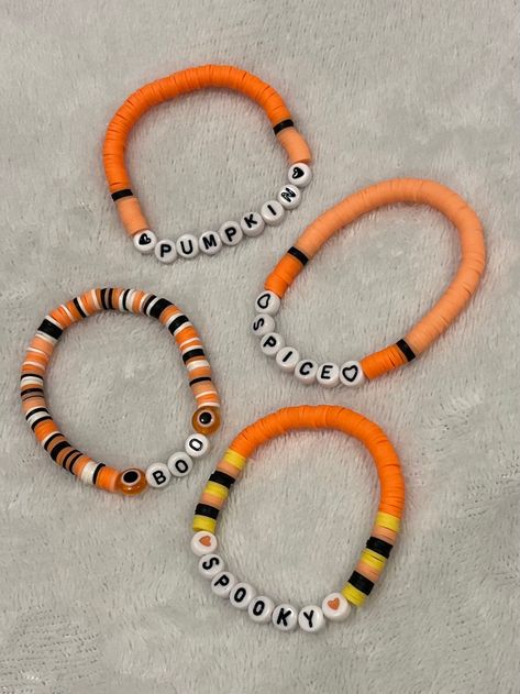 Do you like Halloween and things cute, retro and fun? Look no further! These bracelets will get you into the spooky spirit while also adding some glam. Alphabet beads are used to spell out Halloween themes and are made with the colors black, white, yellow, and a variety shades of orange. One size fits most and is approximately 6.75 inches in circumference.  12 per bracelet Halloween Clay Braclets, Aesthetic Fall Bracelet Ideas, Preppy Halloween Clay Bead Bracelets, Preppy Halloween Bracelet Ideas, Bracelet Ideas For Halloween, Clay Bead Bracelets Ideas Fall, Halloween Themed Bracelets, Halloween Bracelets With Letter Beads And Round Shape, Halloween Letter Beads Bracelet With Round Beads