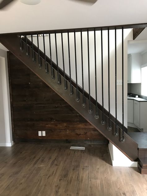 We used metal pipe to create these removable spindles.  Just unscrew and take off for easy access to getting furniture up the steps.  This is a great option for weird angles and we didn’t want to close this in with drywall. Basement Stairwell Railing Ideas, Basement Steps Railing Ideas, Removable Banister Ideas, Basement Step Railing Ideas, Basement Handrail Ideas, Diy Loft Railing Cheap, Basement Railing Ideas, Removable Stair Railing Ideas, Basement Stair Railing Ideas