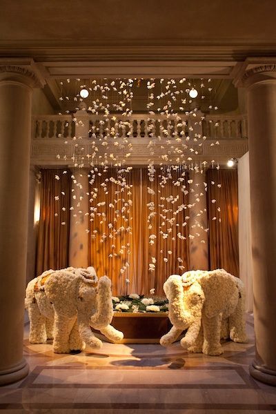 Love this modern indian wedding idea - elephants at the venue entrance (in white flowers) and hanging flowers from the ceiling. Brings such elegance and romance to the venue - it's modern yet still Indian. Great idea for fusion wedding decor too! Hindu Wedding Decorations Indian Theme, Bollywood Night, Egyptian Wedding, Modern Indian Wedding, Kerala Wedding, Indian Wedding Inspiration, Wedding Mandap, Big Fat Indian Wedding, Bay Area Wedding