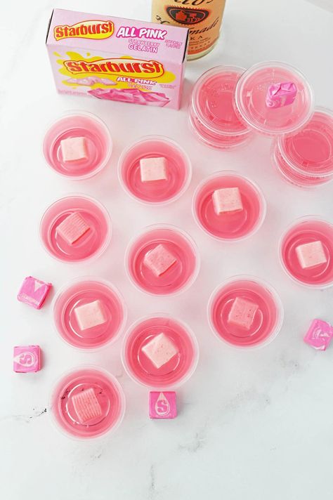 These Starburst Jello shots turn everyone's favorite chewy candies into a fun and delicious Jello shot. These crowd-pleasing boozy pink treats are the perfect way to liven up your next party! Pink Starburst Jello Shots, Starburst Jello Shots, Pink Jello, Strawberry Starburst, Making Jello Shots, Pink Lemonade Vodka, Jello Flavors, Starburst Candy, How To Make Pink