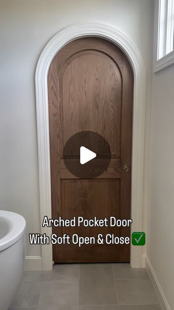 Scott & Britney Anderson • Affordable Home Inspiration on Instagram: "A soft open/close ARCHED door?!! 🤯 what more could you ask for?   Want to know @cardinalcrestkc ‘s secret?   Although the door panel has an arched detail, the door top itself is square. The trim around it is arched to make the door appear arched.   #pocketdoor #archdoor #archdoorway #homielovin  #homieinspo  #builderssecret  #bathroomdoor" Rounded Pocket Doors, Modern Arch Doors, Faux Arched Door, Interior Arched Doors, Arched Bathroom Door, Arched Pocket Doors Interior, Arch Pantry Door, Arch Doors Interior, Arched Doors Interior