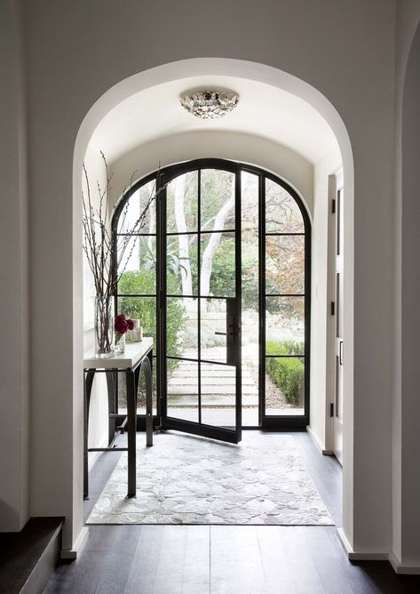 I am torn…I love a glass front door…specifically these steel framed doors…they let in light and bring character into a space from the moment you walk in.  I am torn though as to whether I would want a glass front door.  Have been considering this lately.  You lose privacy…gain light…is safety an issue?…or is style Read More Jenkins Interiors, Arched Doorway, Iron Front Door, Steel Front Door, Grand Entry, Steel Windows, Spanish Style Home, Expensive Taste, Glass Front Door