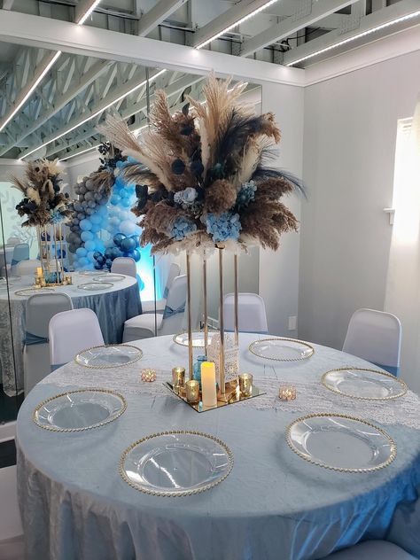 "2 Tall Gold Base Pampas Centerpiece Arrangements rising about 43\" tall from an 8\"base with Blue Florals 1 Wall/Backdrop Mounted Pampas Floral Arrangements measuring about 6' across and 4.5' tall at a depth of 1' 6 Medium Light Blue & White Floral Arrangements 3 Medium Dark Blue Variation Floral Arrangements 18 Bud Vase Arrangements with Blue Florals in Boho Glass Bottle Containers" Dusty Blue Floral Arrangements, Floral Arrangements With Pampas, Pampas Centerpieces, Arrangements With Pampas, Pampas Centerpiece, Blue Floral Arrangements, Blue Flower Centerpieces, Bud Vases Arrangements, Centerpiece Arrangements