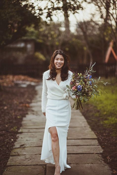 South Asian bride in a fitted wedding dress with front split and wrap cardigan with rosette holding a wildflower wedding bouquet Wedding Dress With Cardigan, Wedding Dress Cardigan, Mermaid Bride Dresses, Indian Bride Dresses, Boho Bride Dress, Princess Bride Dress, Bride Dress Lace, Simple Bride, Bride Dress Simple