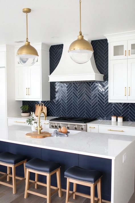 You don't have to settle for a standard subway tile backsplash in your new kitchen - you can instead use a herringbone subway tile backsplash that will really provide a unique and stand-out feature in your kitchen. Take a look at these examples, tips and ideas for more. Navy Kitchen Tiles Backsplash, White Kitchen Navy Backsplash, Mermaid Backsplash Kitchen, Herringbone Kitchen Tiles, Island Tile Ideas, Navy Backsplash Kitchen, White Cabinets Blue Backsplash, Blue Herringbone Tile Bathroom, Blue Herringbone Backsplash