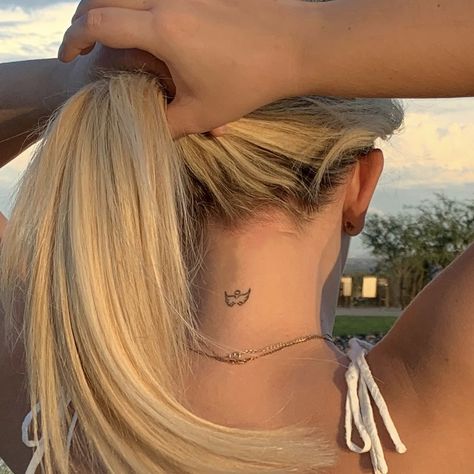 Small angel dainty tattoo at back of neck Dainty Tattoos Harry Styles, Harry Styles Tattoo Minimalist, Harry Styles Tattoo Aesthetic, Minimalistic Harry Styles Tattoo, Dainty Back Of Neck Tattoos For Women, Dainty Tattoos Back, Small Tattoos Harry Styles, Harry Styles Coded Tattoos, Wings Small Tattoo