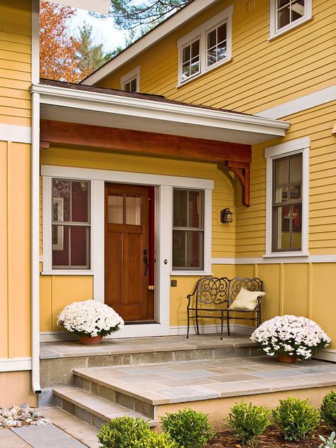 This beautiful wood front door gives guests a warm welcome. More ways to add curb appeal: http://www.bhg.com/home-improvement/exteriors/curb-appeal/ways-to-add-curb-appeal/?socsrc-bhgpin061313tiledoorstep=17 Curb Appeal Porch, Front Porch Design Ideas, Veranda Design, Entryway Light Fixtures, Porch Design Ideas, Front Stoop, Building A Porch, Front Porch Design, Entryway Lighting